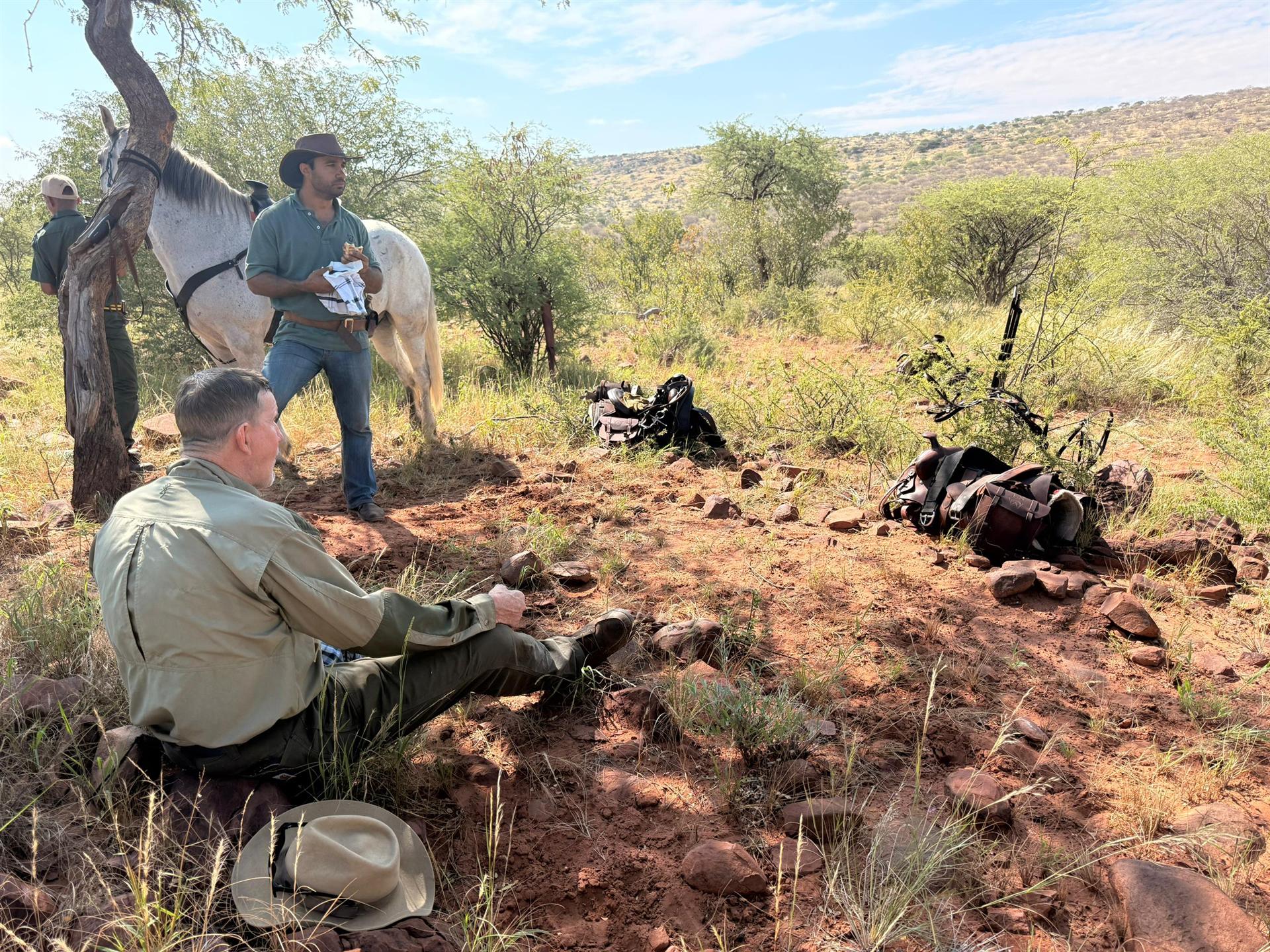 Resting in the shade with the horses, lunch from the saddlebag